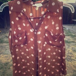 A sleeveless brown polka-dot blouse